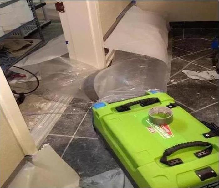 SERVPRO drying equipment placed on messy floor 