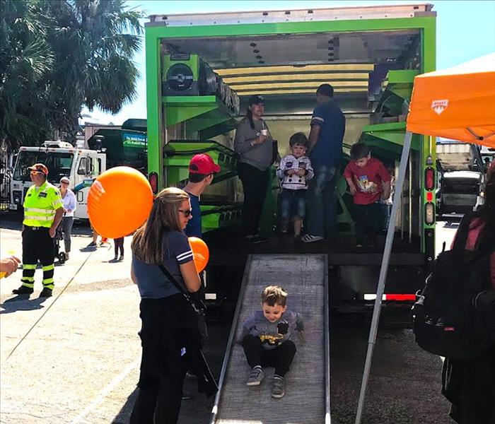 SERVPRO truck at a children's event with kids and balloons