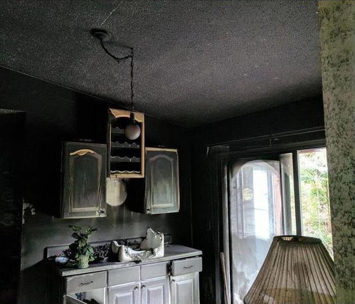 burned kitchen covered in soot