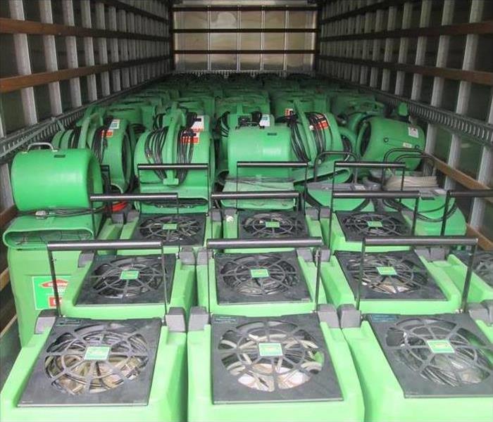 green restoration equipment loaded into truck