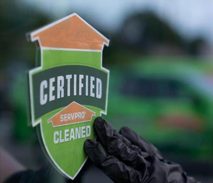 Certified: SERVPRO Cleaned sticker being placed on a business window