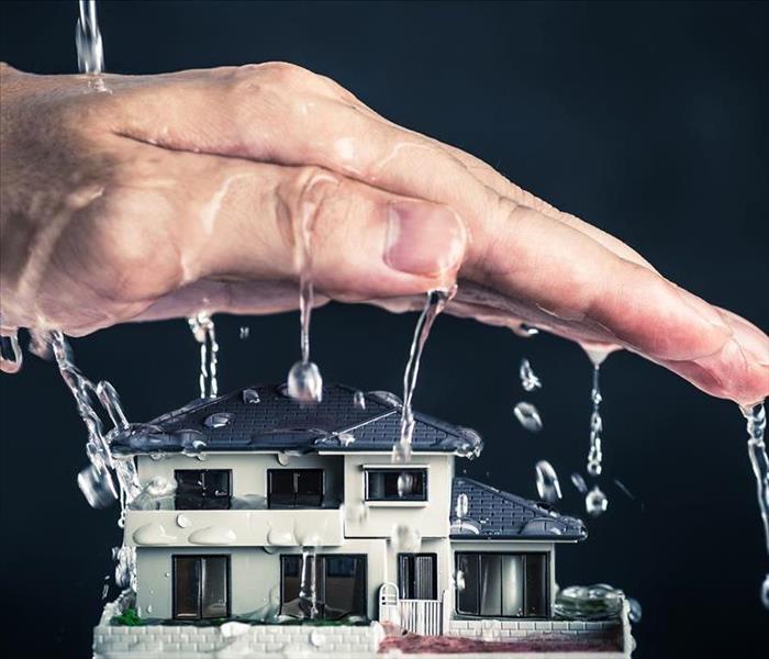 hand covering house with water